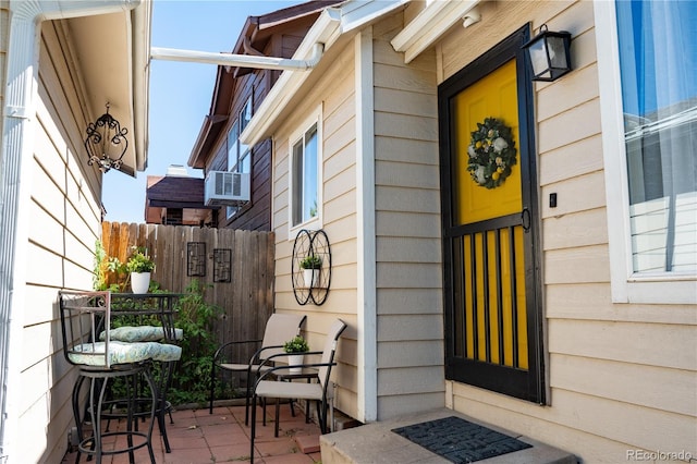 property entrance featuring cooling unit and a patio