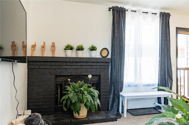 interior details with carpet floors and a fireplace