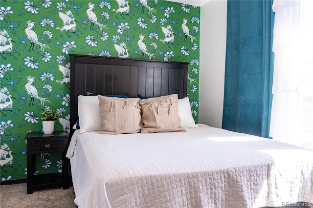 bedroom with carpet floors and wallpapered walls