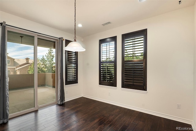 unfurnished dining area featuring dark hardwood / wood-style floors and a healthy amount of sunlight