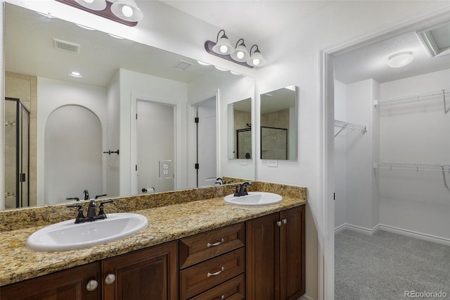 bathroom featuring walk in shower and vanity