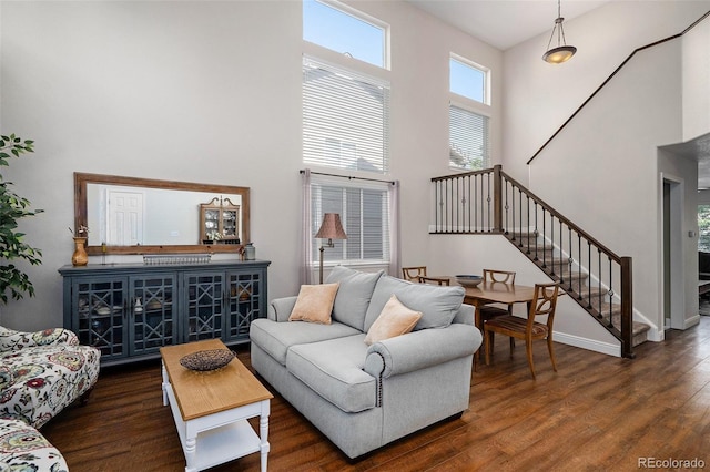 735 Poppy Pl, Highlands Ranch, CO 80129 - living area featuring a towering ceiling, stairs, and dark wood-type flooring
