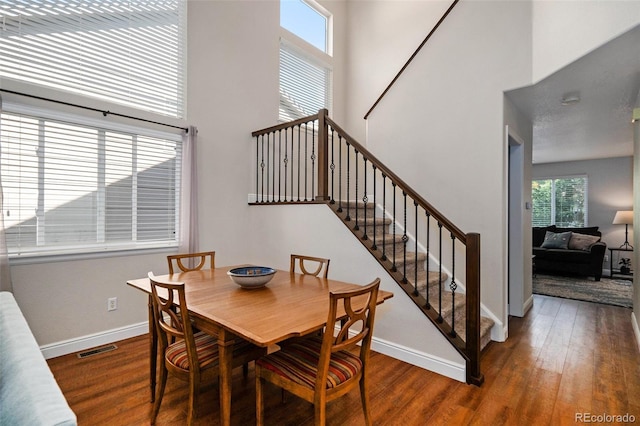 735 Poppy Pl, Highlands Ranch, CO 80129 - dining space with a high ceiling, wood finished floors, and stairs