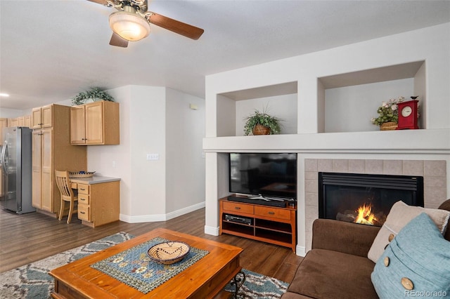 735 Poppy Pl, Highlands Ranch, CO 80129 - living area featuring a ceiling fan, dark wood-style floors, a tile fireplace, and a desk