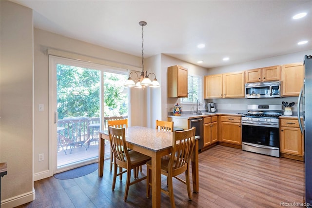 735 Poppy Pl, Highlands Ranch, CO 80129 - kitchen with stainless steel appliances, dark wood-style flooring, a chandelier, light countertops, and recessed lighting