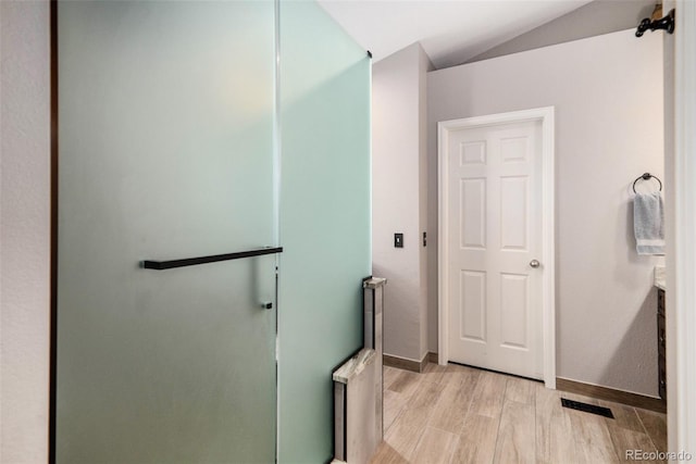735 Poppy Pl, Highlands Ranch, CO 80129 - full bath featuring wood finished floors, lofted ceiling, vanity, and a shower with door