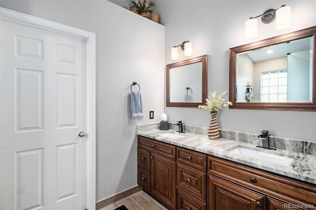 735 Poppy Pl, Highlands Ranch, CO 80129 - bathroom featuring double vanity and baseboards