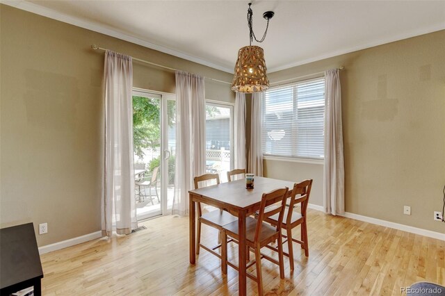 13025 Umatilla Ct, Denver, CO 80234 - dining area featuring plenty of natural light, light wood-style floors, a chandelier, and crown molding