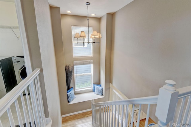 13025 Umatilla Ct, Denver, CO 80234 - staircase featuring healthy amount of natural light, a chandelier, and wood finished floors