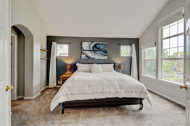13025 Umatilla Ct, Denver, CO 80234 - bedroom with vaulted ceiling, multiple windows, carpet flooring, and arched walkways