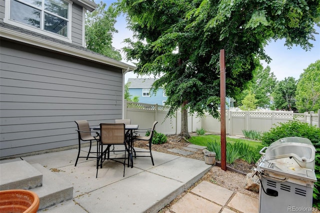 13025 Umatilla Ct, Denver, CO 80234 - fenced backyard with a patio area, outdoor dining area, and a grill