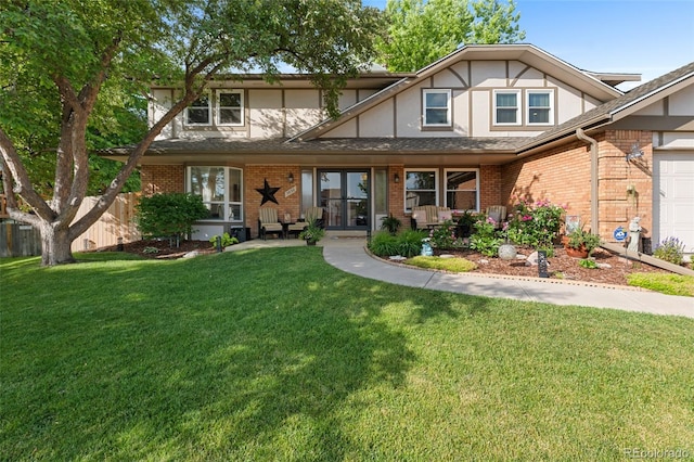 7830 W Friend Pl, Littleton, CO 80128 - tudor-style house with brick siding, a front lawn, and roof with shingles