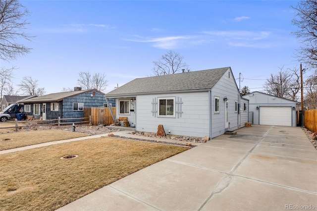 view of front of home with a garage, an outdoor structure, and a front yard