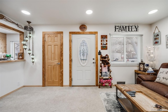 carpeted foyer entrance featuring a healthy amount of sunlight