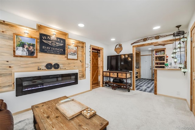 carpeted living room with wood walls