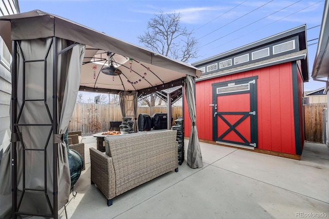 view of patio / terrace featuring a gazebo, an outdoor fire pit, and a storage unit