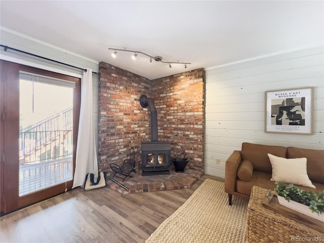 living room featuring wood finished floors and a wood stove