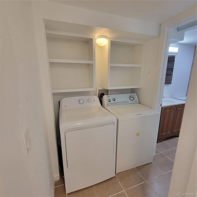 970 S Peoria St, Aurora, CO 80012 - washroom featuring washing machine and dryer and light tile patterned floors