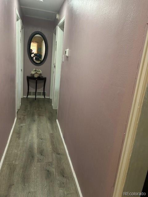 corridor with dark hardwood / wood-style floors