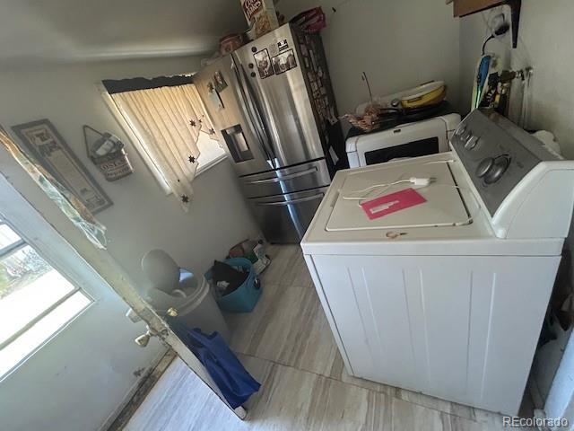 clothes washing area featuring independent washer and dryer