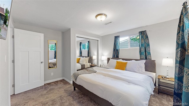 carpeted bedroom with a closet