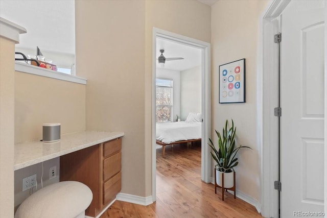 bathroom with ceiling fan and wood-type flooring