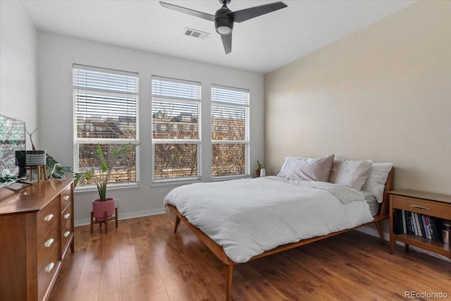 bedroom featuring ceiling fan and dark hardwood / wood-style floors