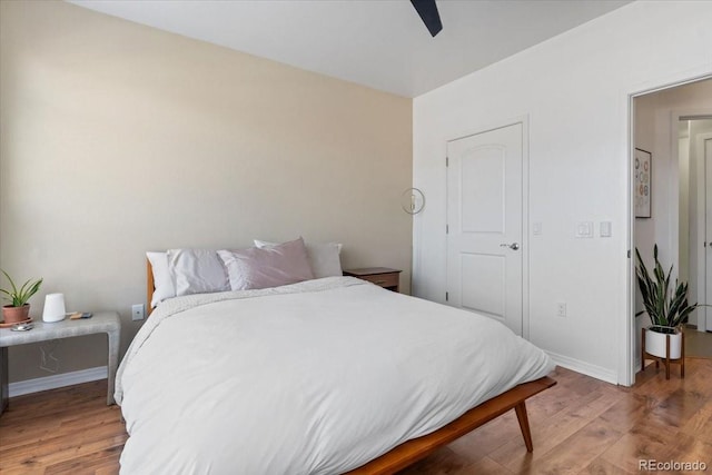 bedroom with wood-type flooring and ceiling fan