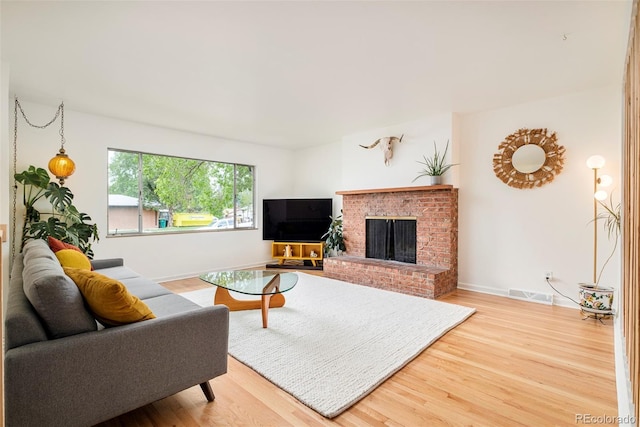 12193 W New Mexico Pl, Lakewood, CO 80228 - living area featuring wood finished floors, a fireplace, and baseboards