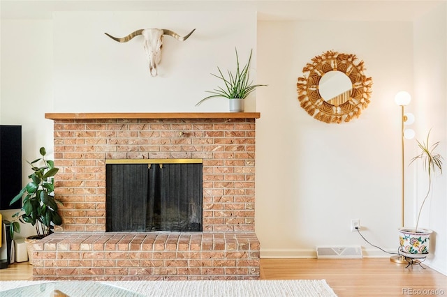 12193 W New Mexico Pl, Lakewood, CO 80228 - detailed view of wood finished floors, a fireplace, and baseboards
