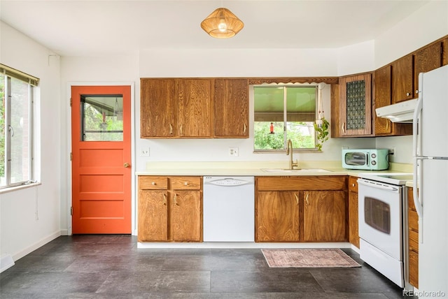 12193 W New Mexico Pl, Lakewood, CO 80228 - kitchen featuring white appliances, a sink, brown cabinets, and healthy amount of natural light
