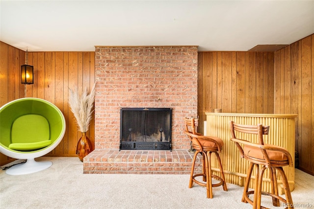 12193 W New Mexico Pl, Lakewood, CO 80228 - carpeted living area with wooden walls and a brick fireplace