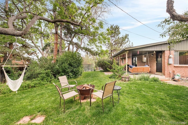 12193 W New Mexico Pl, Lakewood, CO 80228 - view of grassy yard with an outdoor fire pit