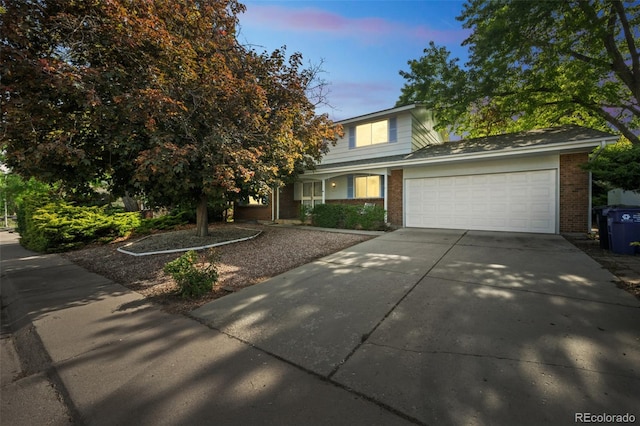 4474 S Vrain St, Denver, CO 80236 - traditional home with brick siding, an attached garage, and concrete driveway