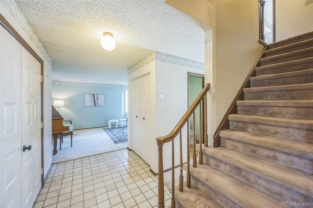 4474 S Vrain St, Denver, CO 80236 - stairway featuring carpet, a textured ceiling, tile patterned flooring, and baseboards