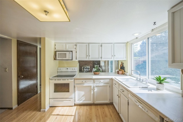 4474 S Vrain St, Denver, CO 80236 - kitchen with white appliances, a sink, light wood finished floors, light countertops, and white cabinetry