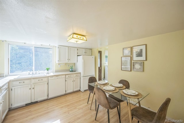 4474 S Vrain St, Denver, CO 80236 - kitchen featuring white appliances, a sink, light wood-style floors, light countertops, and white cabinetry
