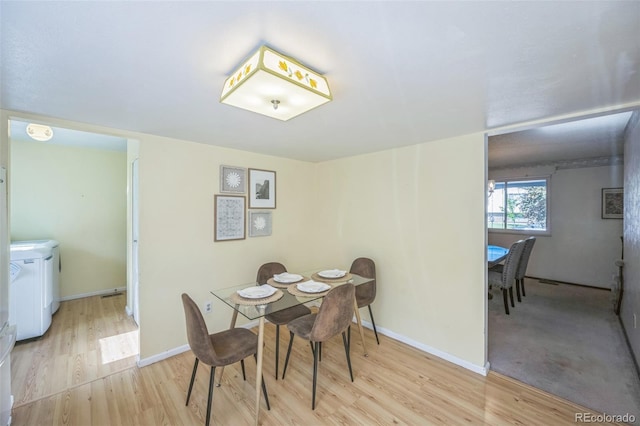 4474 S Vrain St, Denver, CO 80236 - dining area with light wood finished floors, baseboards, and separate washer and dryer