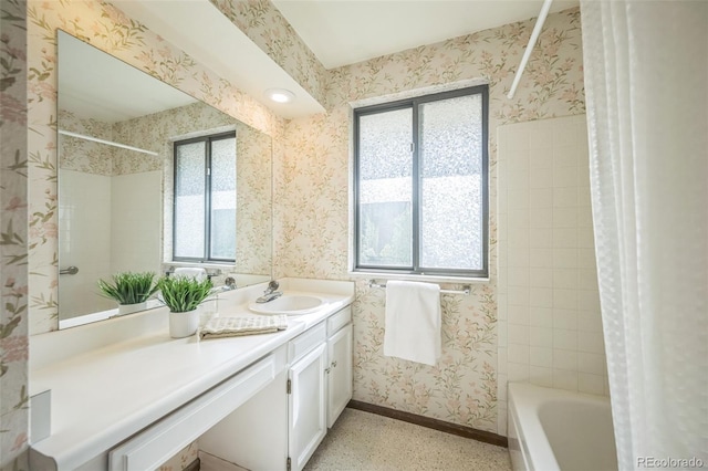 4474 S Vrain St, Denver, CO 80236 - full bath featuring wallpapered walls, vanity, shower / bath combination with curtain, and baseboards