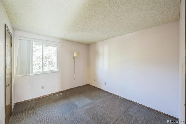 4474 S Vrain St, Denver, CO 80236 - unfurnished room featuring a textured ceiling and dark colored carpet