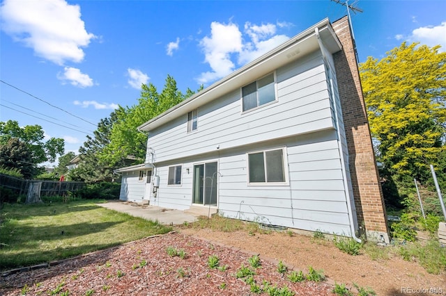 4474 S Vrain St, Denver, CO 80236 - rear view of house with a chimney and a patio area