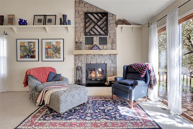 living area with a fireplace, lofted ceiling, and carpet flooring