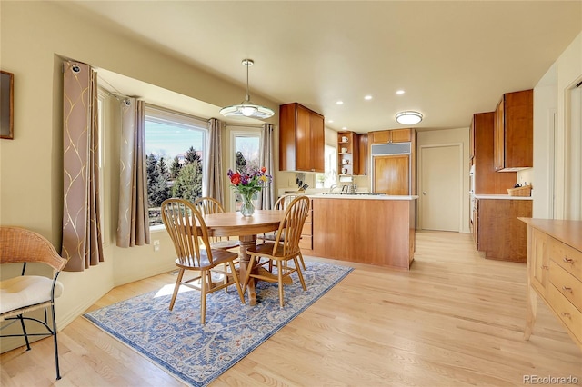dining area with a healthy amount of sunlight, light wood-style floors, and recessed lighting