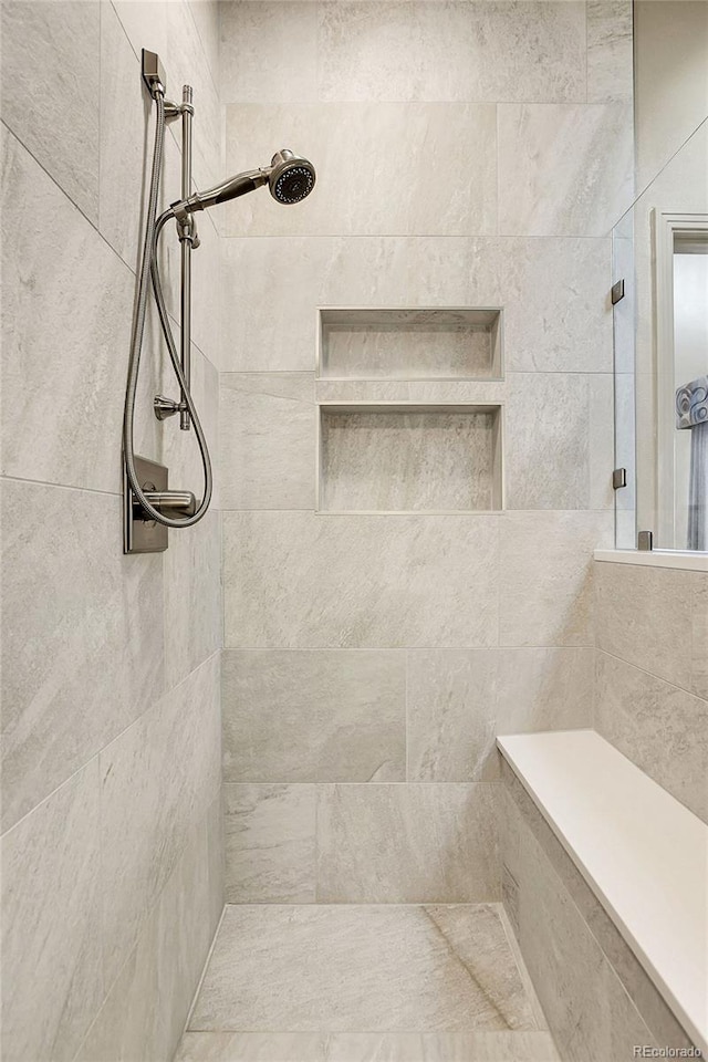 full bath featuring a tile shower