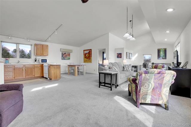 living room with recessed lighting, track lighting, light carpet, a wall mounted AC, and high vaulted ceiling