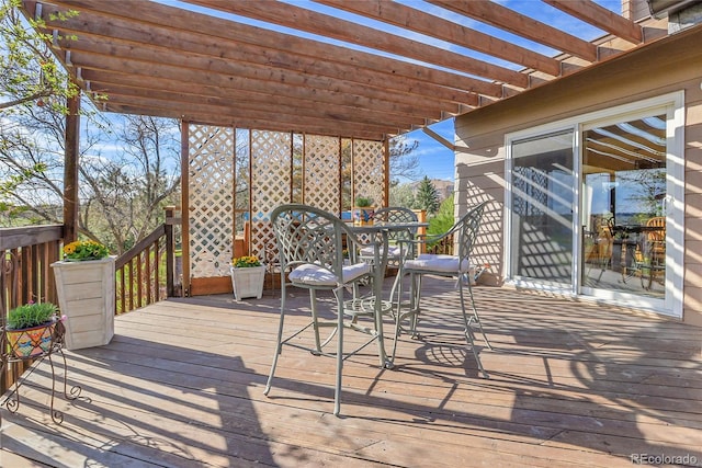 wooden deck featuring a pergola and outdoor dining area