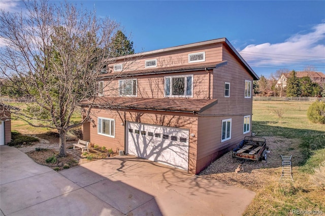 view of side of home with a garage, a lawn, and concrete driveway