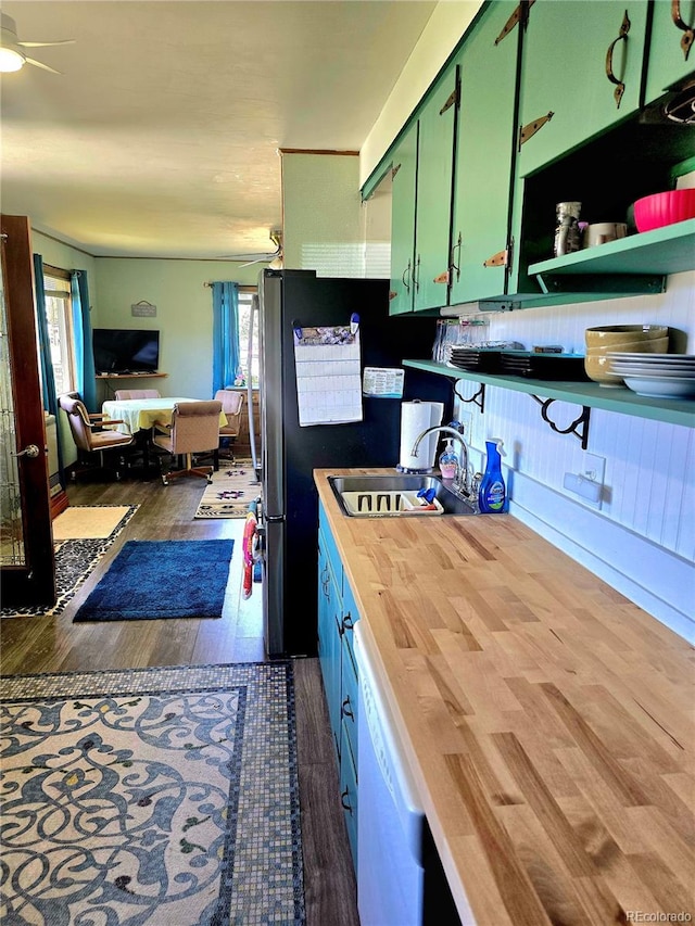 kitchen with green cabinetry, white dishwasher, ceiling fan, dark hardwood / wood-style floors, and sink