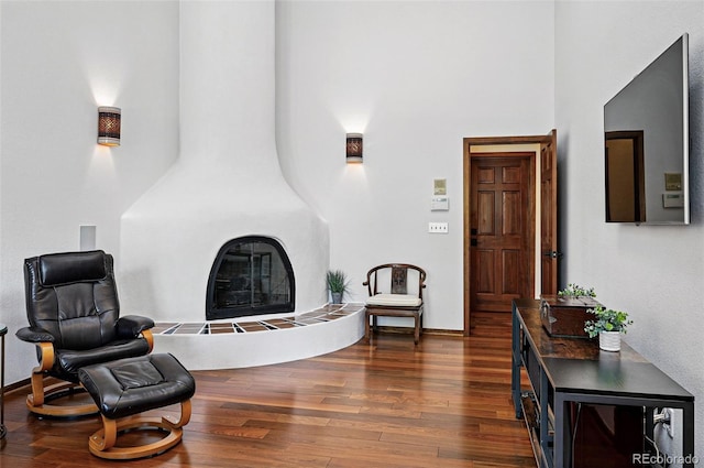 5904 Meadowbrook Dr, Morrison, CO 80465 - living area with a towering ceiling, dark wood-style floors, a fireplace, and baseboards