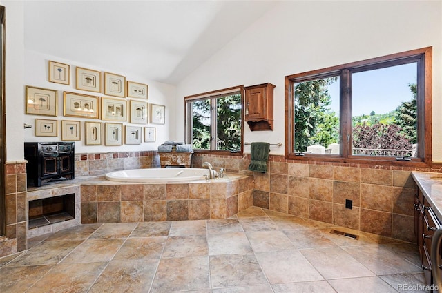 5904 Meadowbrook Dr, Morrison, CO 80465 - bathroom featuring a bath, vanity, high vaulted ceiling, and a wood stove